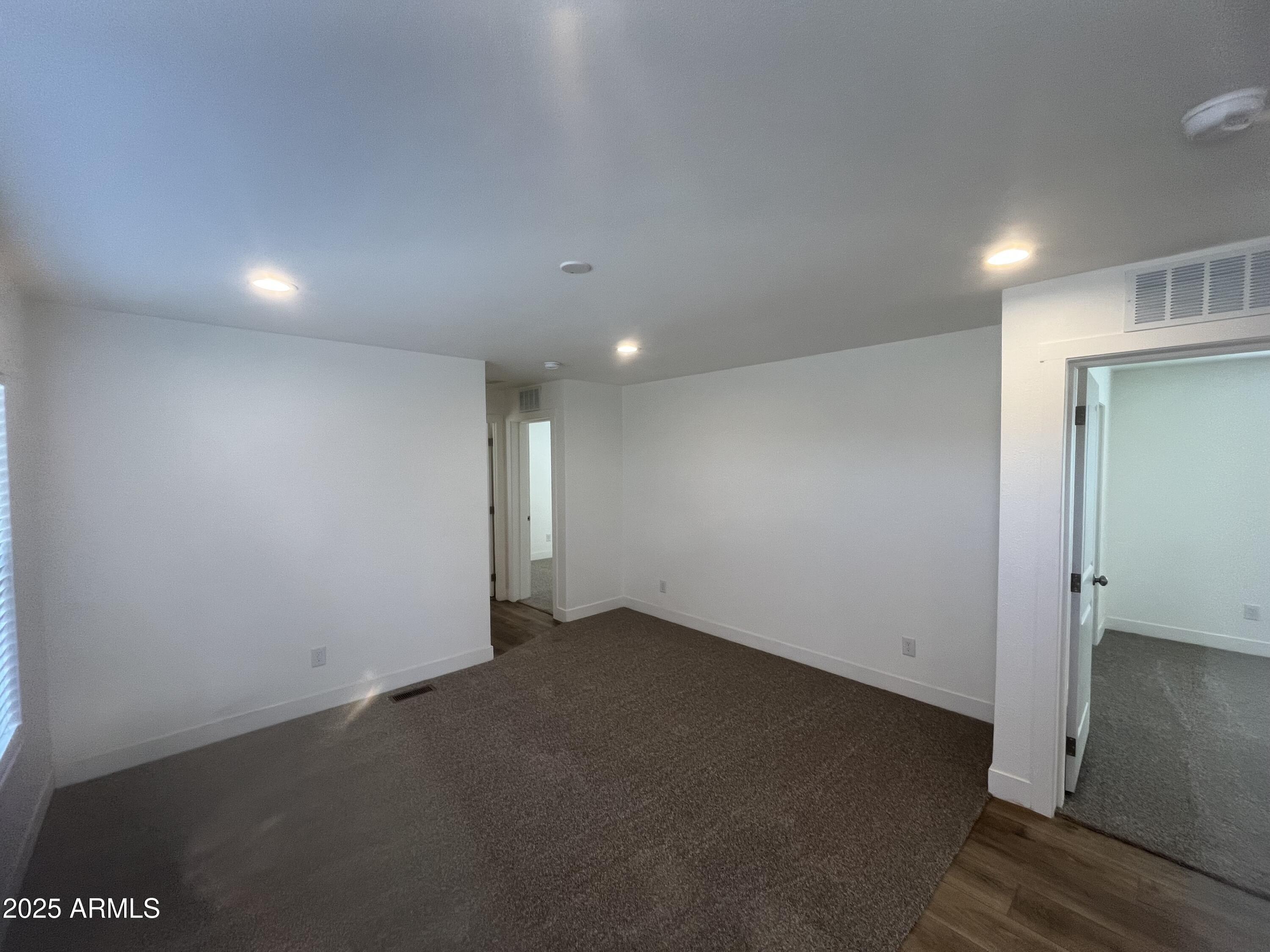 22936 West Forest Pleasant Place, Unit 2 Wittmann, AZ 85361 - Photo 6 of 17 an empty room with a empty space and windows