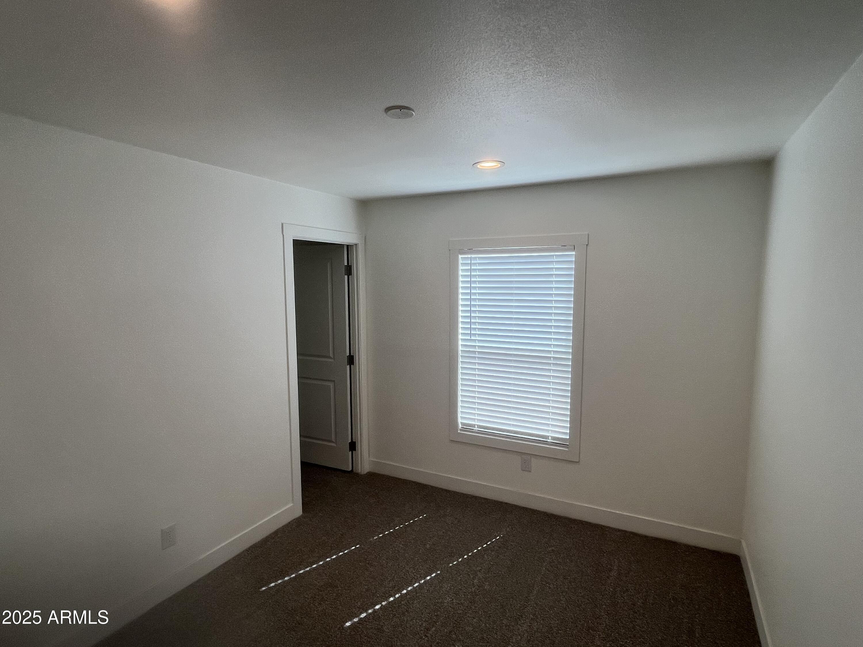 22936 West Forest Pleasant Place, Unit 2 Wittmann, AZ 85361 - Photo 10 of 17 an empty room with windows