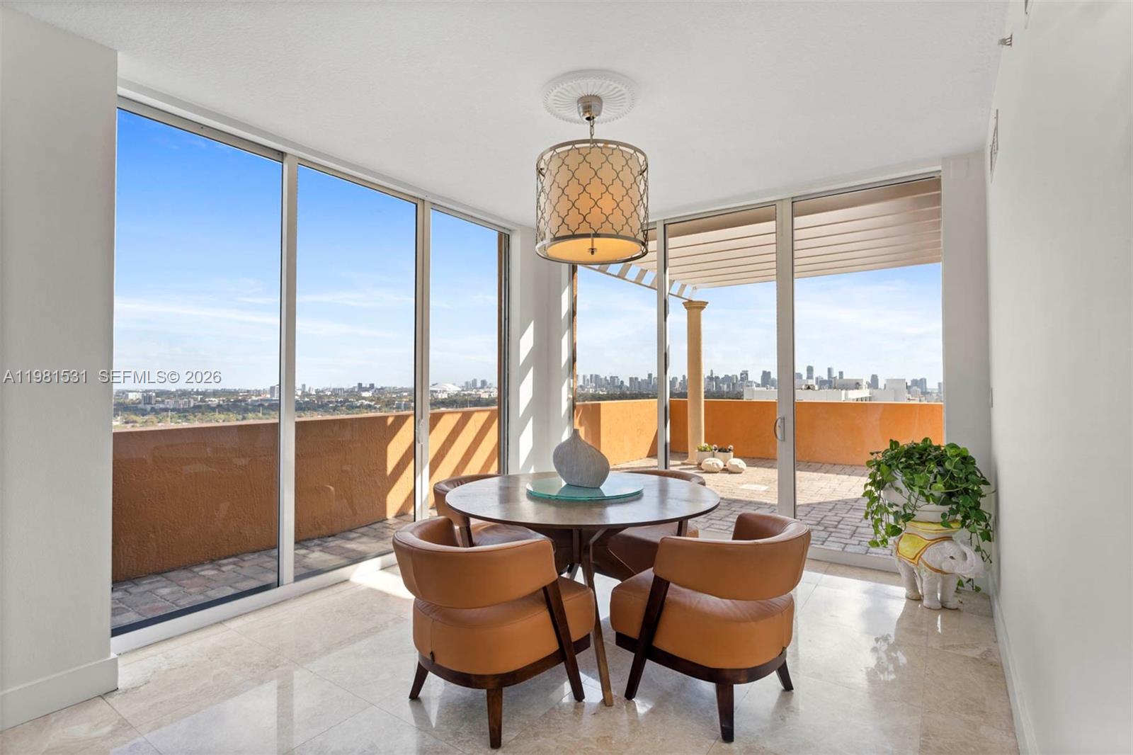 3232 Southwest 22nd Terrace, Unit PH2002 Miami, FL 33145 - Photo 11 of 35 a view of a dining room with furniture window and outside view