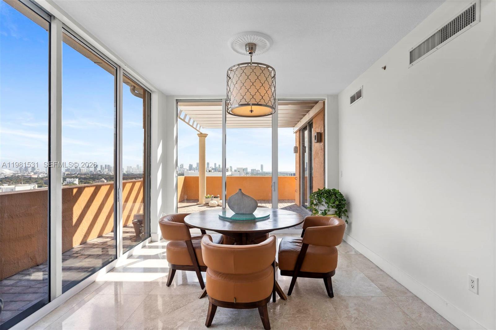 3232 Southwest 22nd Terrace, Unit PH2002 Miami, FL 33145 - Photo 12 of 35 a view of a dining room with furniture window and outside view