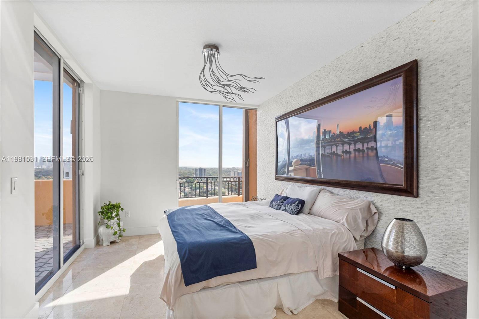 3232 Southwest 22nd Terrace, Unit PH2002 Miami, FL 33145 - Photo 17 of 35 a bedroom with a large bed and a window