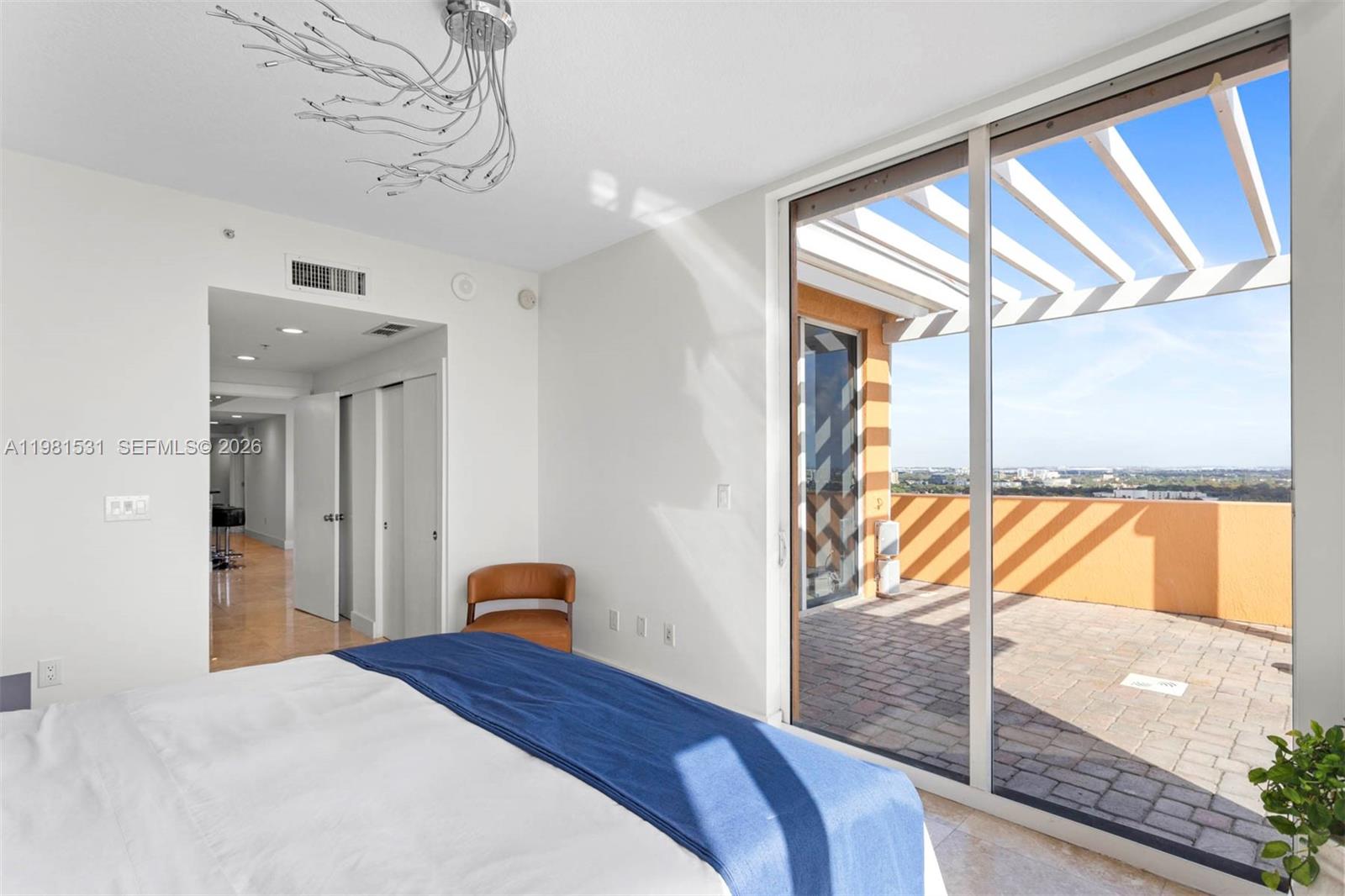 3232 Southwest 22nd Terrace, Unit PH2002 Miami, FL 33145 - Photo 18 of 35 a bedroom with a bed and a window