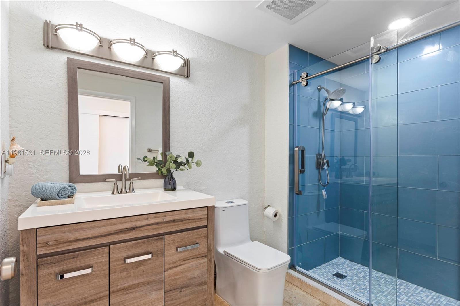 3232 Southwest 22nd Terrace, Unit PH2002 Miami, FL 33145 - Photo 19 of 35 a bathroom with a sink a toilet and shower