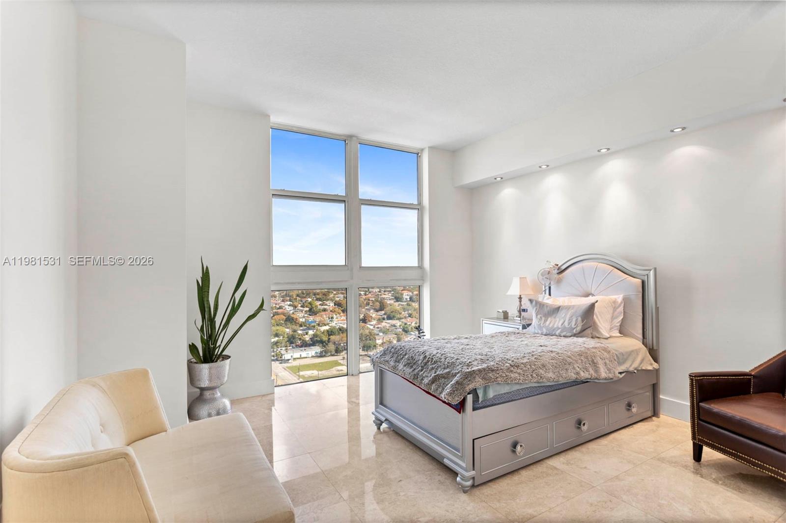 3232 Southwest 22nd Terrace, Unit PH2002 Miami, FL 33145 - Photo 21 of 35 a bedroom with a bed and a couch