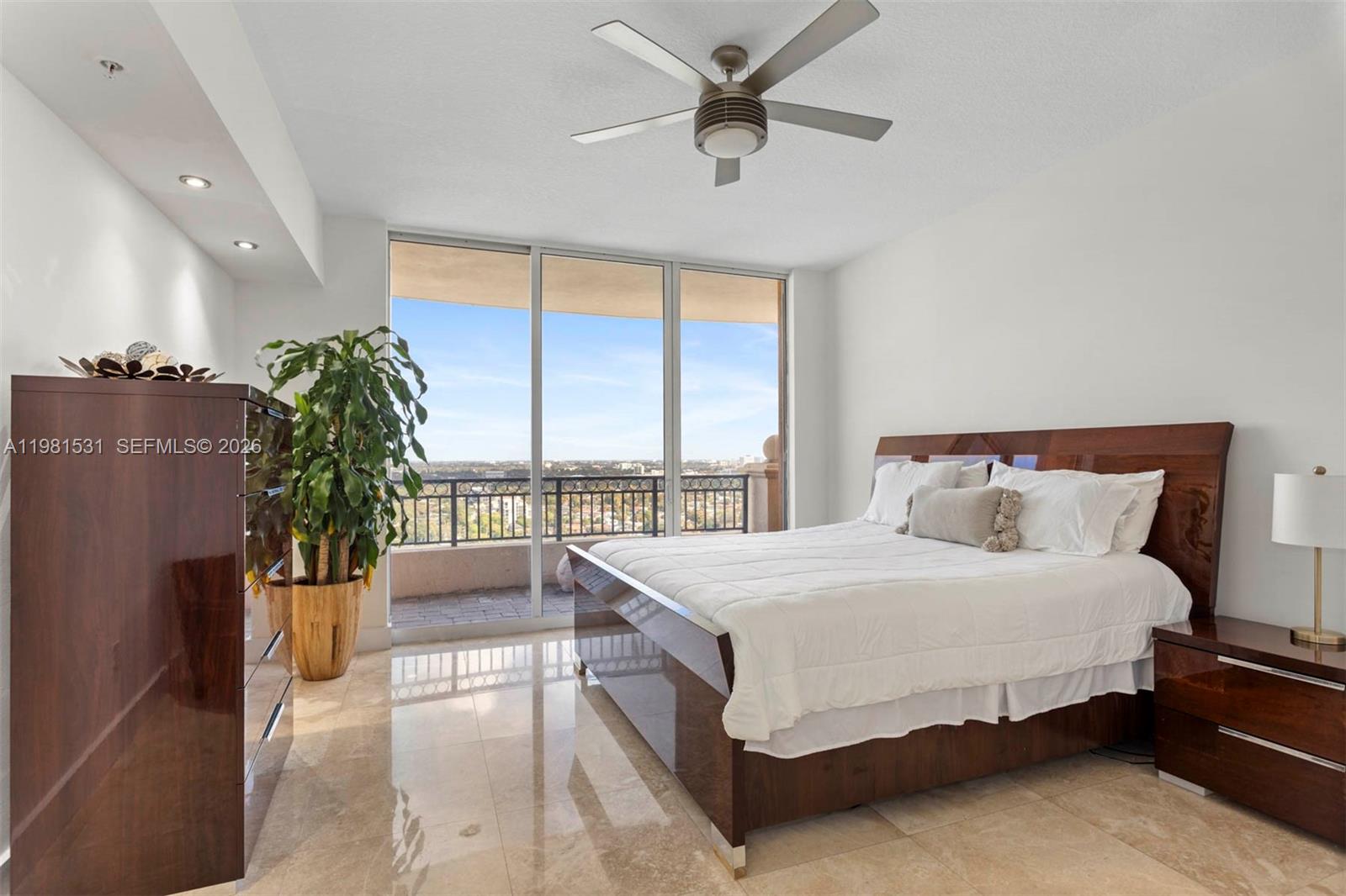 3232 Southwest 22nd Terrace, Unit PH2002 Miami, FL 33145 - Photo 22 of 35 a spacious bedroom with a bed and a large window