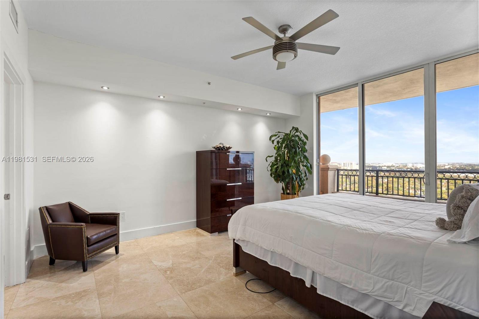 3232 Southwest 22nd Terrace, Unit PH2002 Miami, FL 33145 - Photo 23 of 35 a bedroom with a bed and a large window