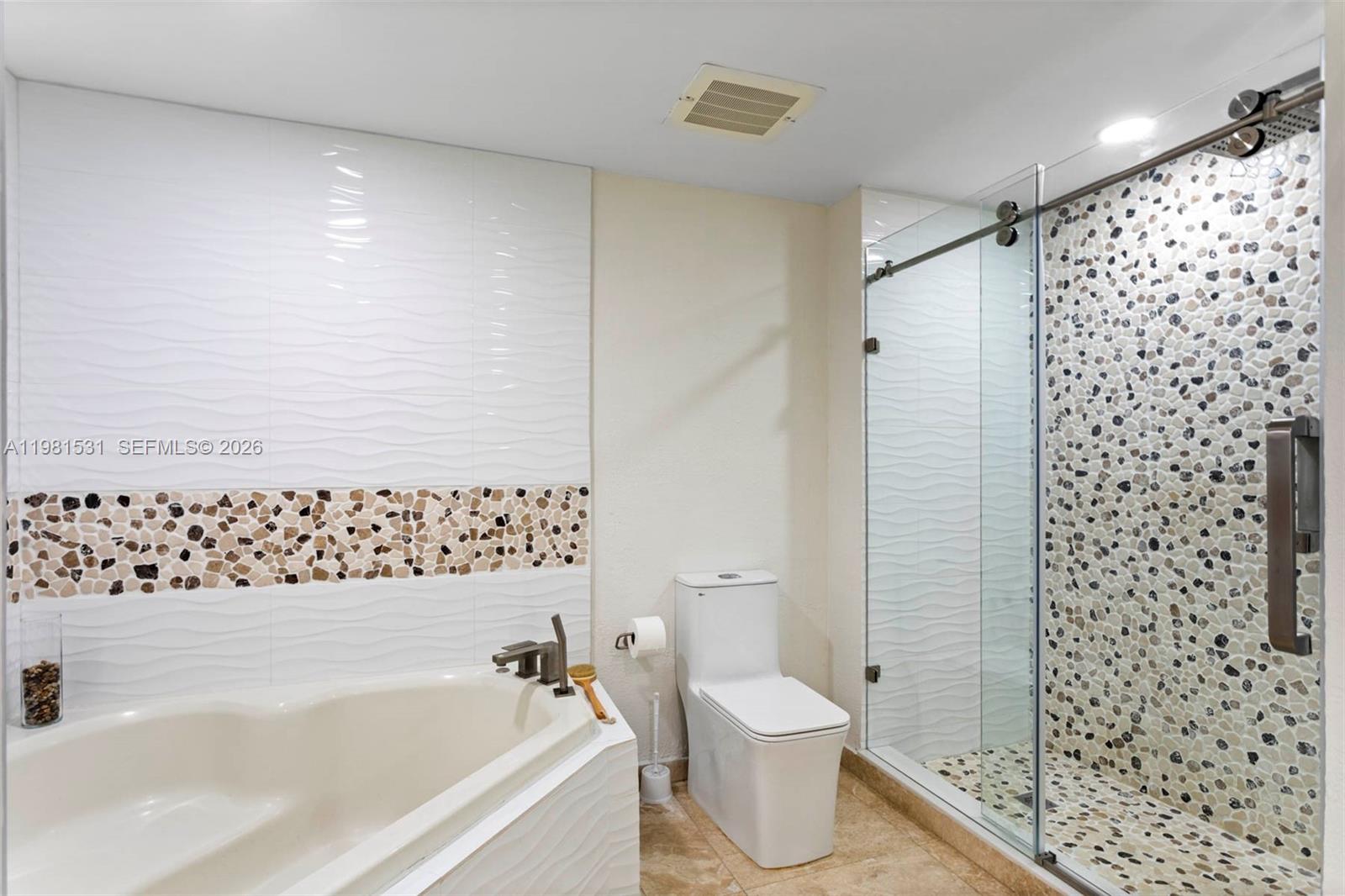 3232 Southwest 22nd Terrace, Unit PH2002 Miami, FL 33145 - Photo 26 of 35 a bathroom with a bathtub and a toilet