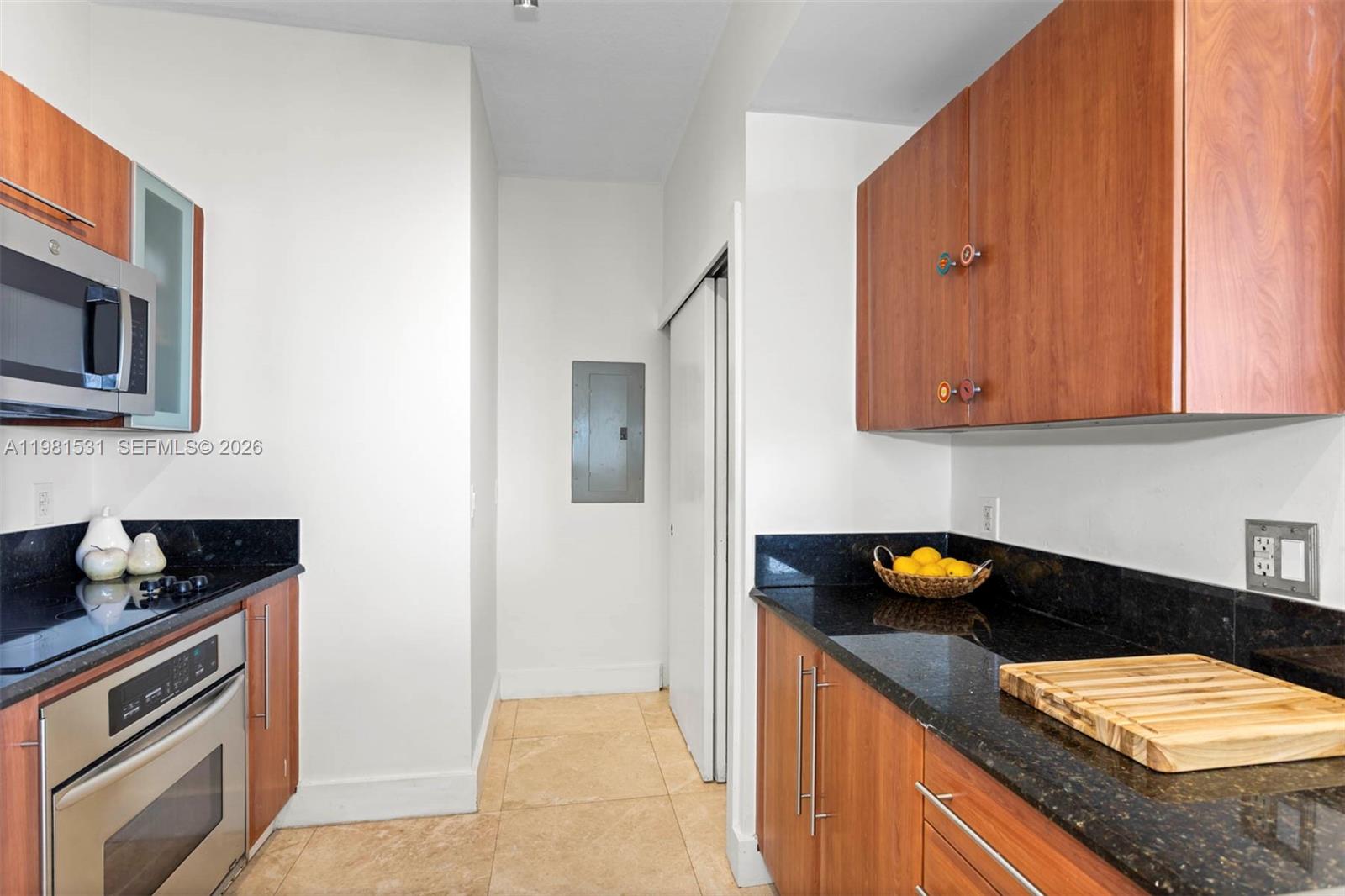 3232 Southwest 22nd Terrace, Unit PH2002 Miami, FL 33145 - Photo 5 of 35 a kitchen with a sink a stove and cabinets
