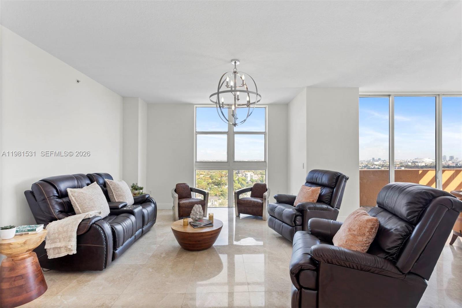 3232 Southwest 22nd Terrace, Unit PH2002 Miami, FL 33145 - Photo 9 of 35 a living room with furniture and a large window