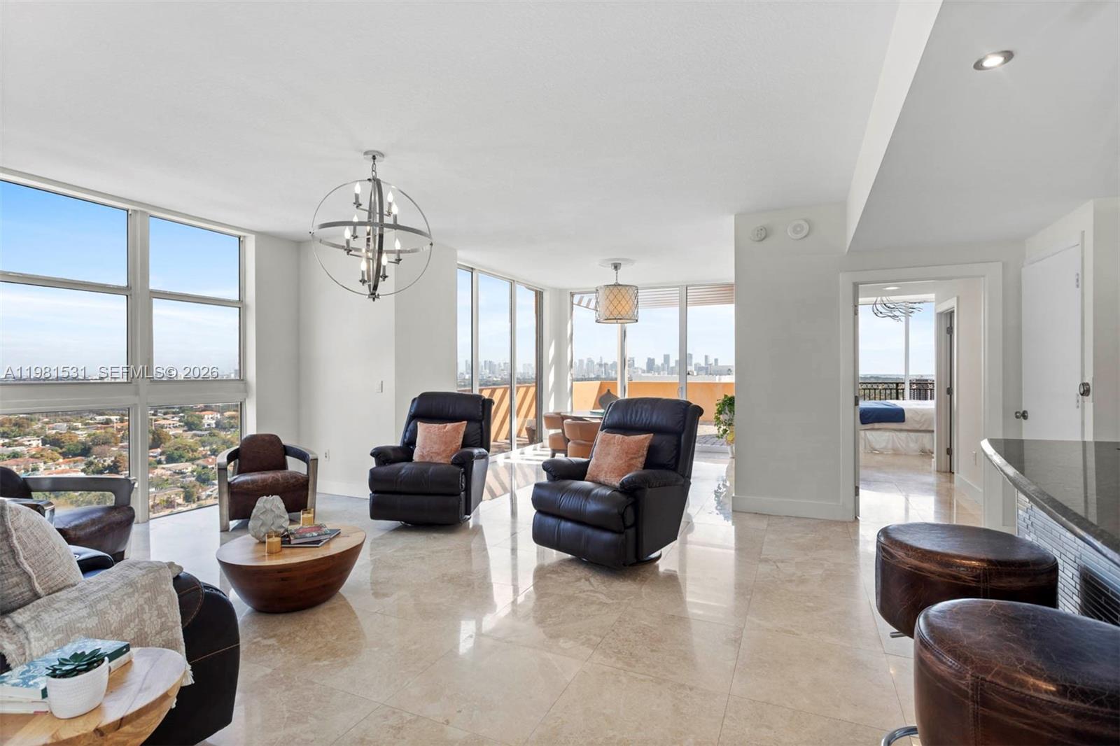 3232 Southwest 22nd Terrace, Unit PH2002 Miami, FL 33145 - Photo 10 of 35 a living room with furniture and a large window