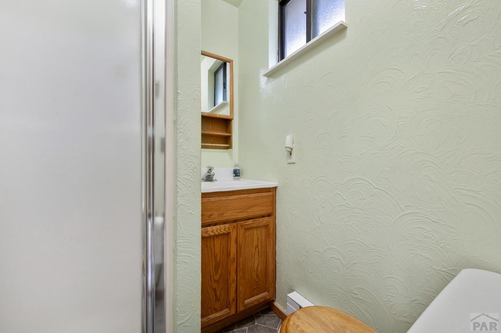 9600 Middle Creek Canyon Road Beulah, CO 81023 - Photo 40 of 50 a bathroom with a sink a toilet and mirror