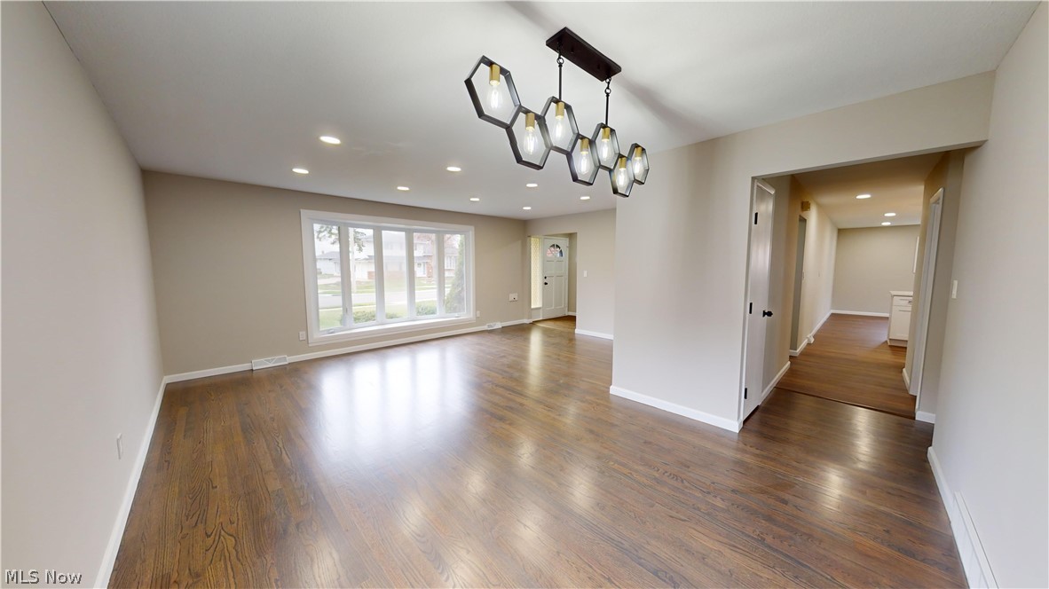 1224 Cordova Road Mayfield Heights, OH 44124 - Photo 3 of 29 Spare room featuring a notable chandelier and dark hardwood / wood-style floors