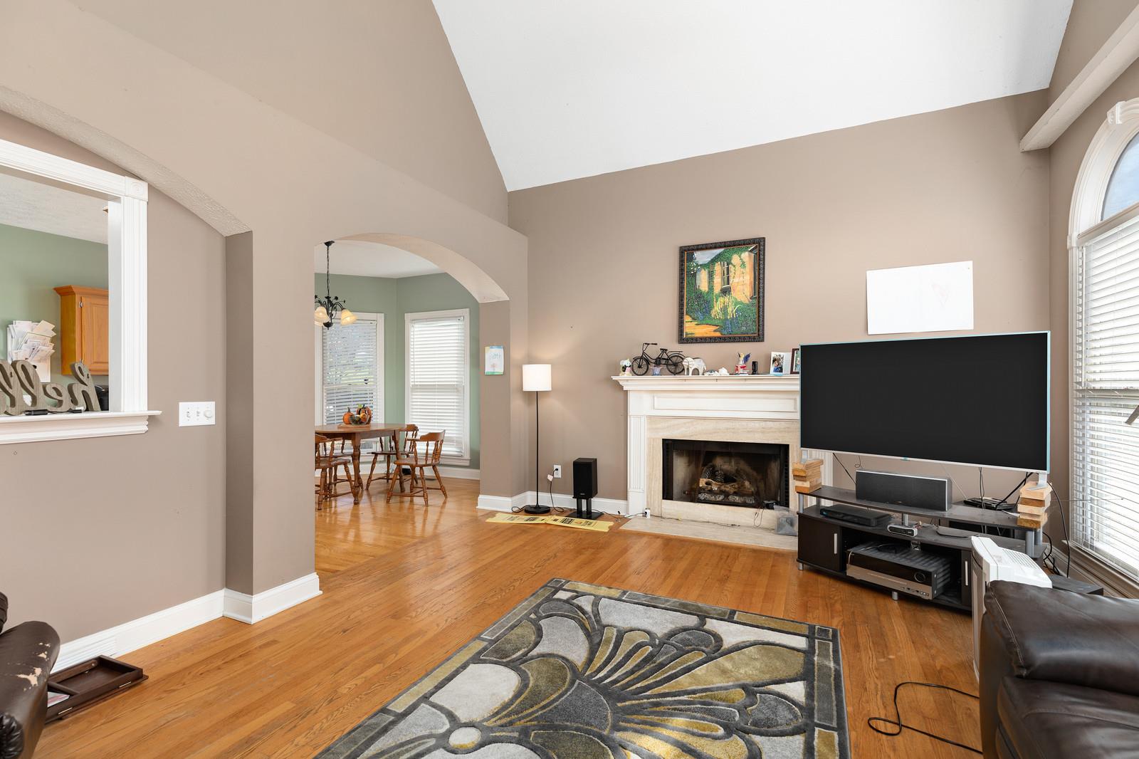 133 East Robertson Road Castalian Springs, TN 37031 - Photo 12 of 28 Beautiful fireplace and hardwood flooring complement the moulding and arched doorways.