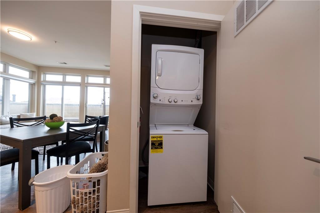 1655 Fifth Avenue, Unit 312 Pittsburgh, PA 15219 - Photo 19 of 29 a utility room with dryer washer and a view of living room