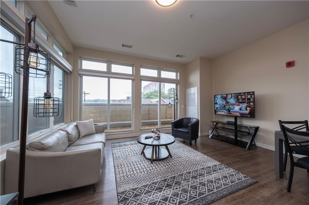 1655 Fifth Avenue, Unit 312 Pittsburgh, PA 15219 - Photo 20 of 29 a living room with furniture and a large window