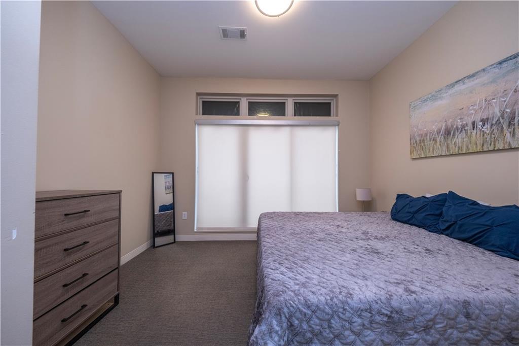 1655 Fifth Avenue, Unit 312 Pittsburgh, PA 15219 - Photo 22 of 29 a bedroom with a bed and a window
