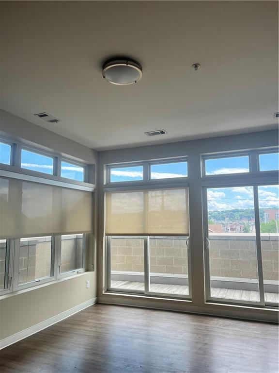 1655 Fifth Avenue, Unit 312 Pittsburgh, PA 15219 - Photo 25 of 29 an empty room with wooden floor and windows