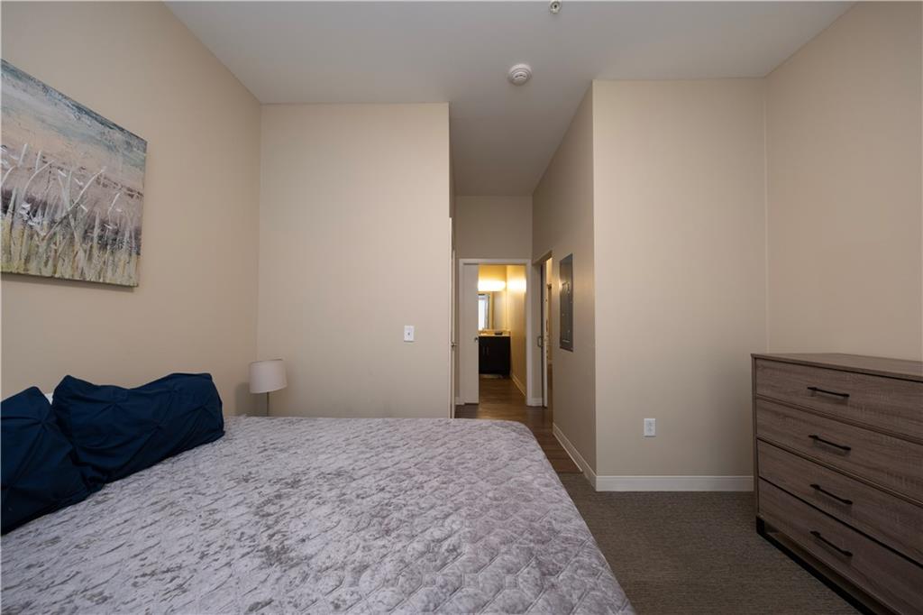 1655 Fifth Avenue, Unit 312 Pittsburgh, PA 15219 - Photo 27 of 29 a bedroom with a bed and a painting on the wall