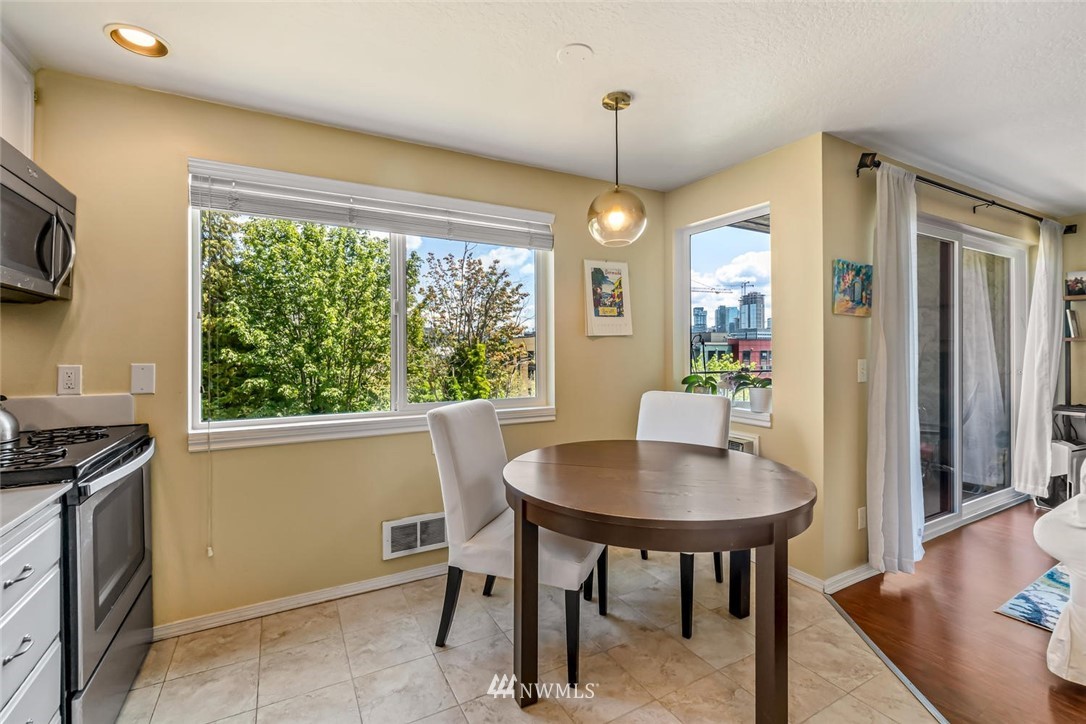 610 Aloha Street, Unit 302 Seattle, WA 98109 - Photo 13 of 27 a view of a dining room with furniture window and outside view