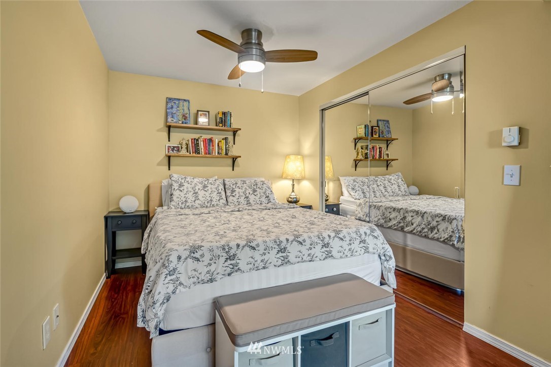 610 Aloha Street, Unit 302 Seattle, WA 98109 - Photo 14 of 27 a bedroom with a bed and a chandelier