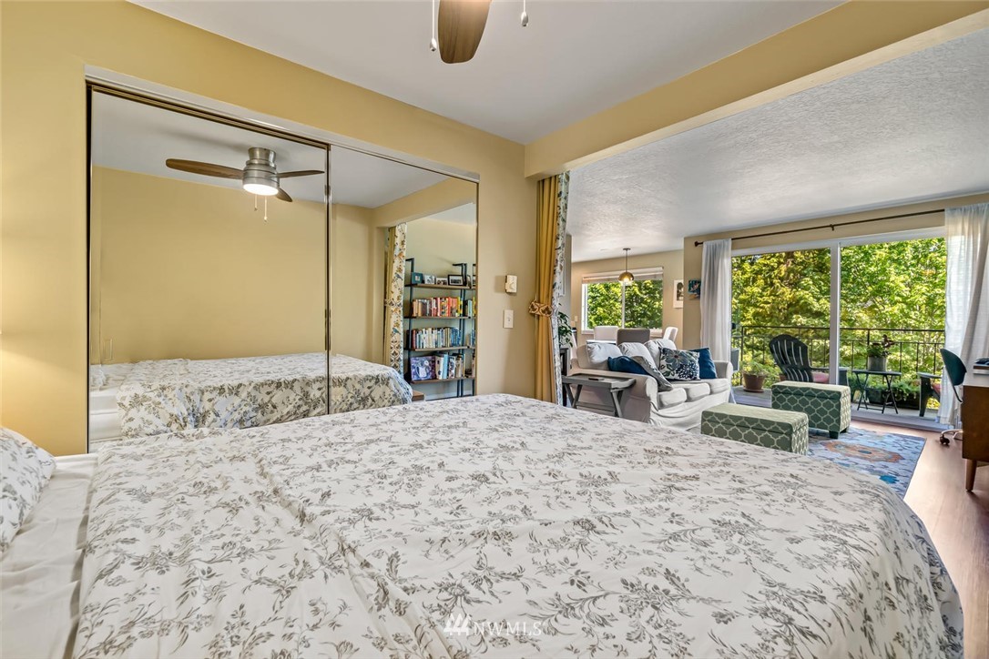 610 Aloha Street, Unit 302 Seattle, WA 98109 - Photo 15 of 27 a bedroom with a bed and large windows