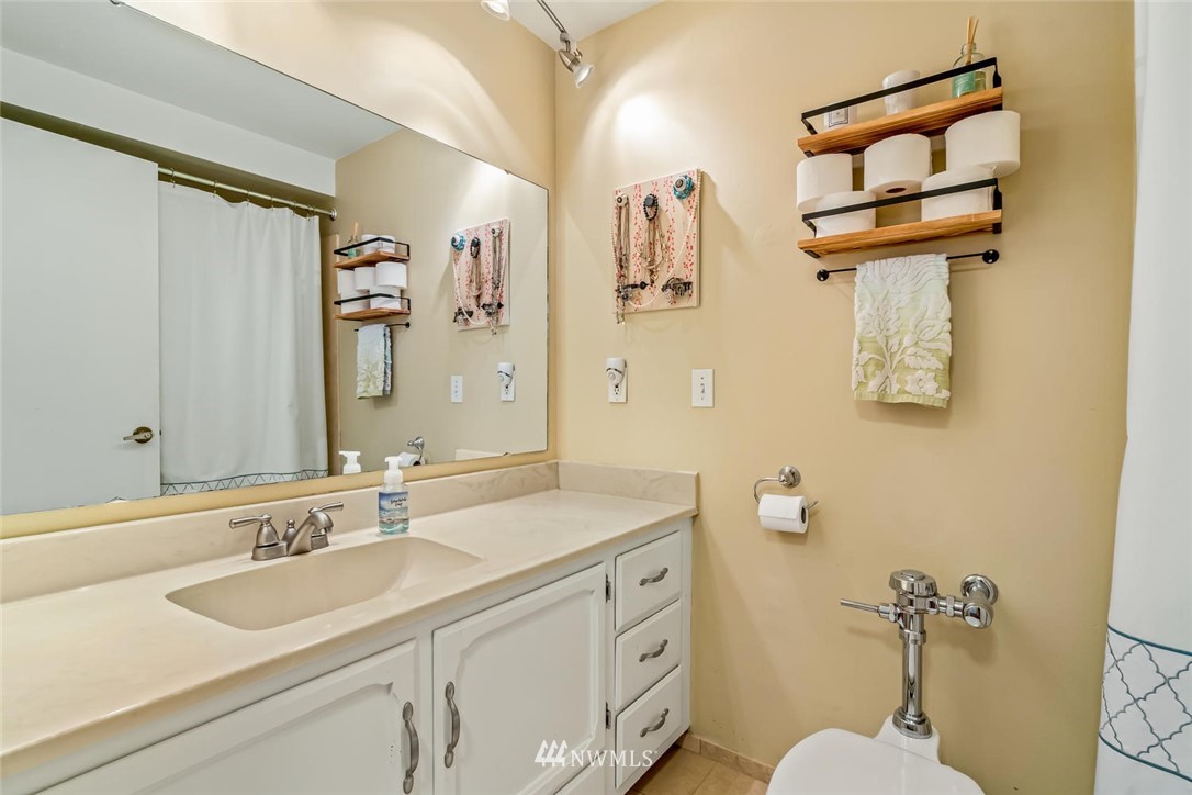 610 Aloha Street, Unit 302 Seattle, WA 98109 - Photo 16 of 27 a bathroom with a sink and a mirror