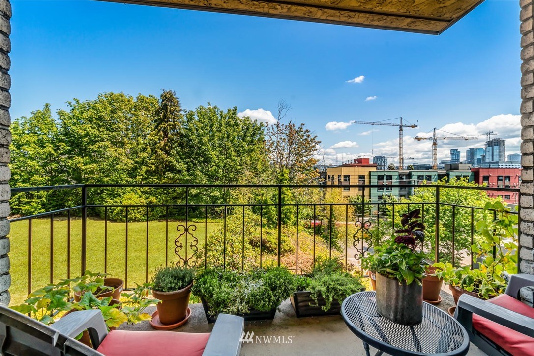 610 Aloha Street, Unit 302 Seattle, WA 98109 - Photo 18 of 27 a view of a lake with couches chairs and a potted plant