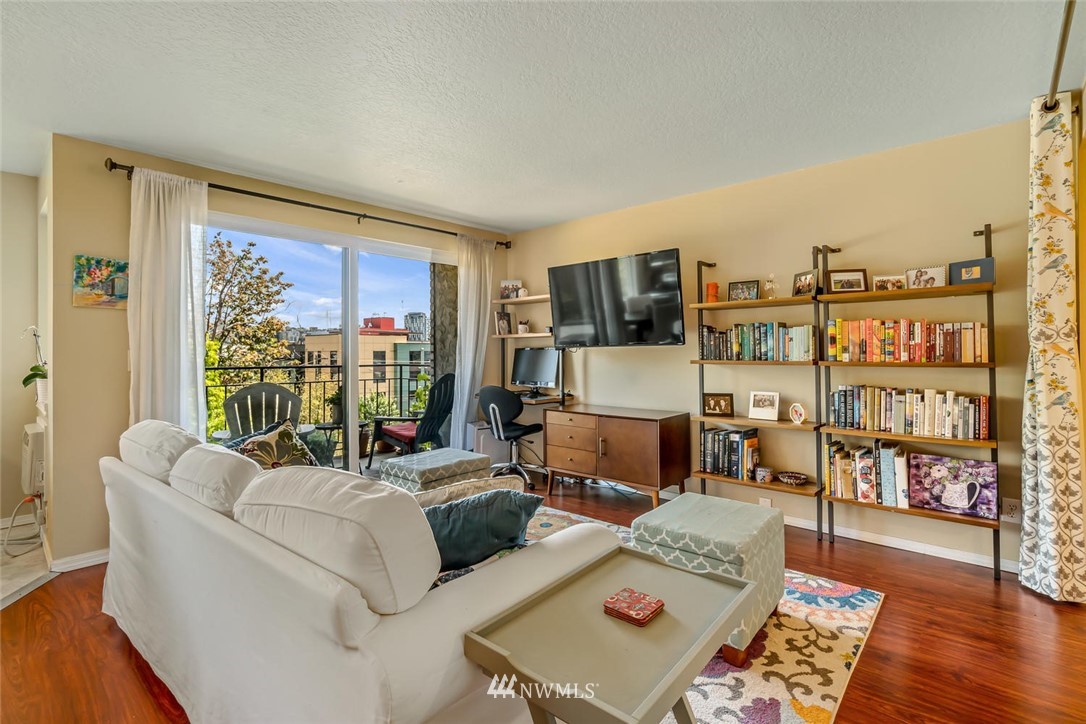 610 Aloha Street, Unit 302 Seattle, WA 98109 - Photo 6 of 27 a living room with furniture and a flat screen tv