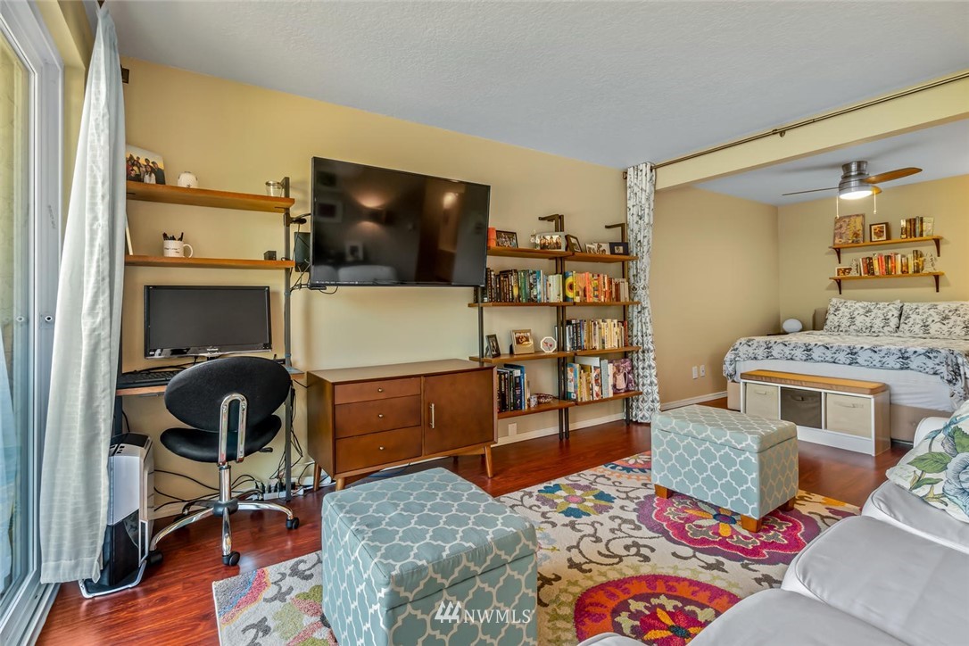 610 Aloha Street, Unit 302 Seattle, WA 98109 - Photo 8 of 27 a living room with furniture and a flat screen tv