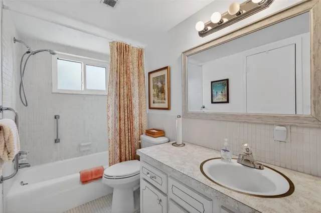 a bathroom with a sink a toilet and bathtub