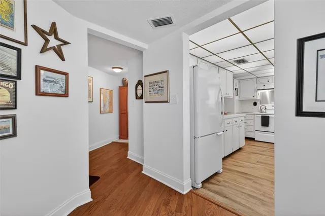 a kitchen with white cabinets and white appliances
