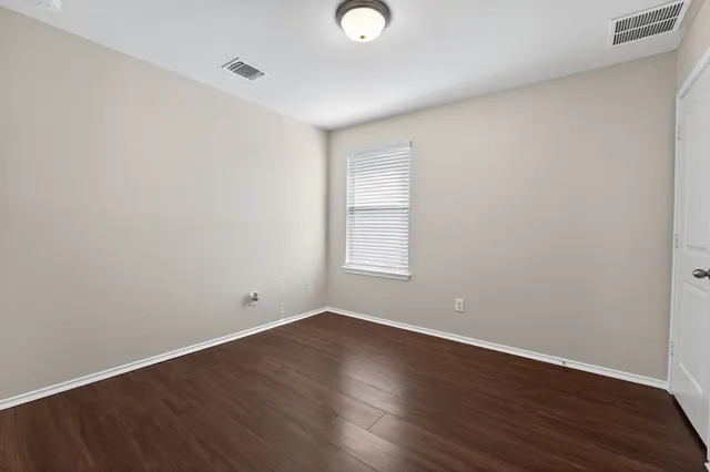 a view of kitchen with granite countertop cabinets a stove a sink and a window