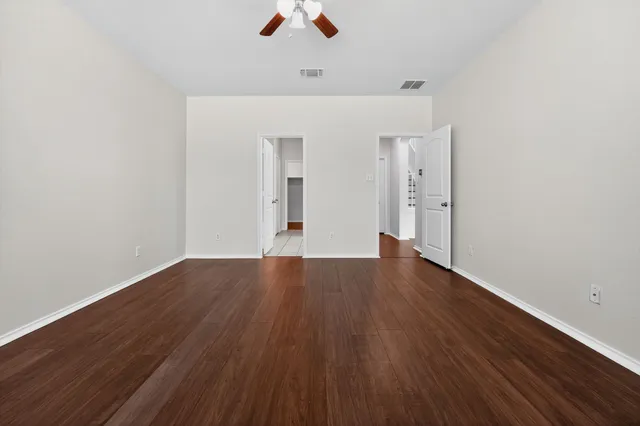 a bathroom with a granite countertop sink a toilet a mirror and shower