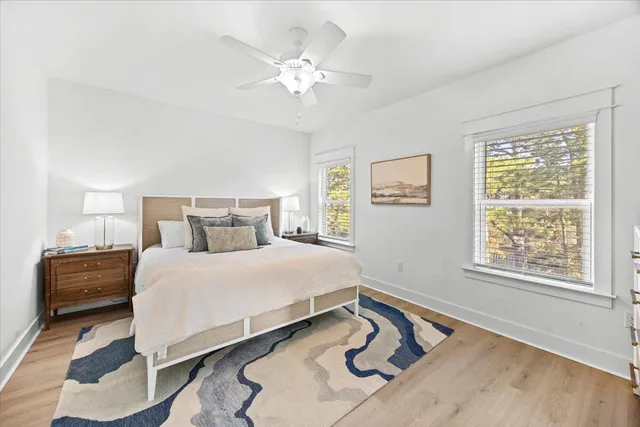 a bedroom with a bed a dresser and a flat screen tv