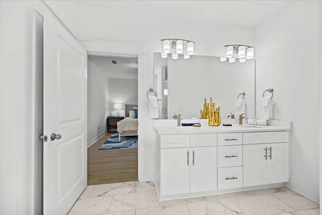 a en suite bathroom with a shower sink and mirror