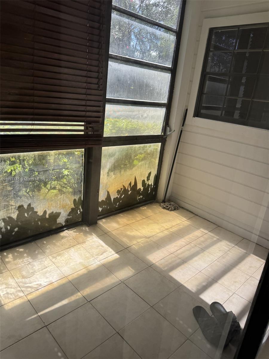 827 Northeast 199th Street, Unit 102 Miami, FL 33179 - Photo 5 of 6 a view of front door