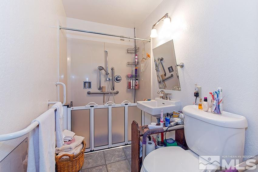 725 Reeves Avenue Reno, NV 89503 - Photo 11 of 15 a bathroom with a sink mirror vanity and toilet