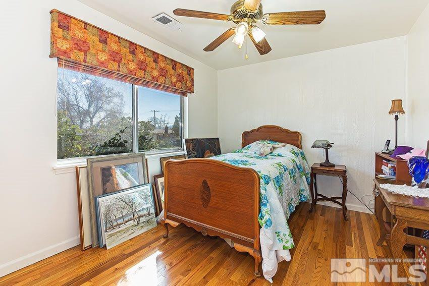 725 Reeves Avenue Reno, NV 89503 - Photo 12 of 15 a bedroom with a bed and wooden floor