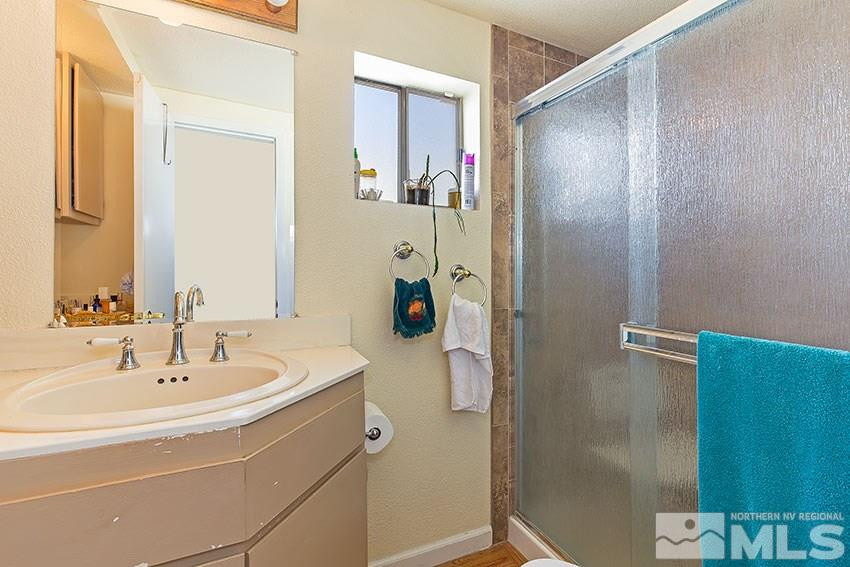 725 Reeves Avenue Reno, NV 89503 - Photo 6 of 15 a bathroom with a sink and a mirror