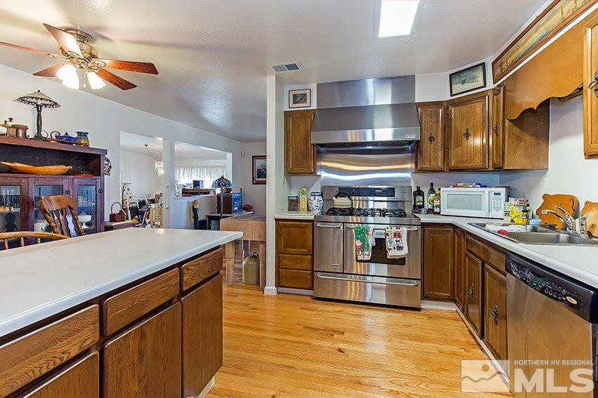 725 Reeves Avenue Reno, NV 89503 - Photo 8 of 15 a kitchen with stainless steel appliances granite countertop a sink and cabinets