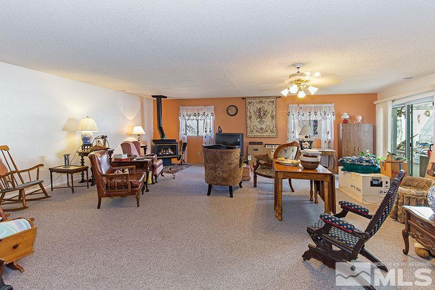 725 Reeves Avenue Reno, NV 89503 - Photo 9 of 15 a living room with furniture and a chandelier