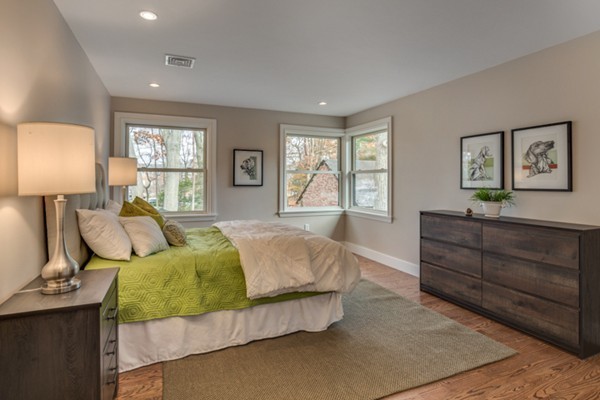 265 Woodland Road Brookline, MA 02467 - Photo 23 of 30 a spacious bedroom with a bed and window with lamp