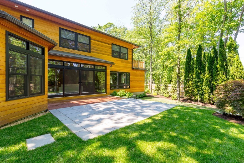 265 Woodland Road Brookline, MA 02467 - Photo 29 of 30 a view of a house with backyard and porch