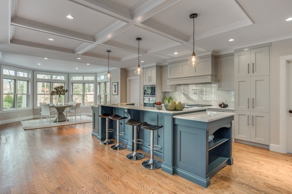 265 Woodland Road Brookline, MA 02467 - Photo 4 of 30 a kitchen with kitchen island granite countertop a large counter top space a sink stainless steel appliances and cabinets