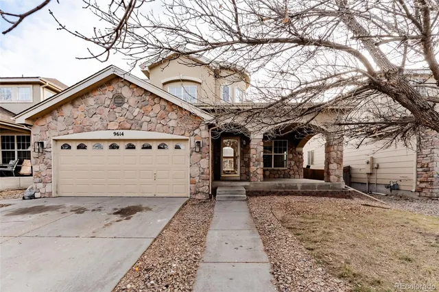 a view of a house with a large tree