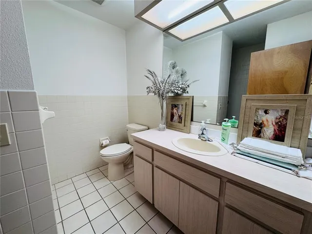 a bathroom with a double vanity sink toilet and a mirror