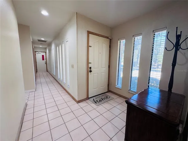 a view of a hallway with bathroom
