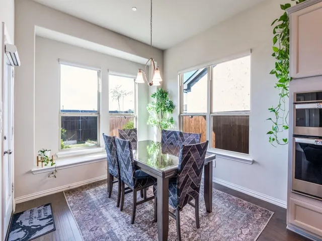 a bedroom with a bed lamp and a large window