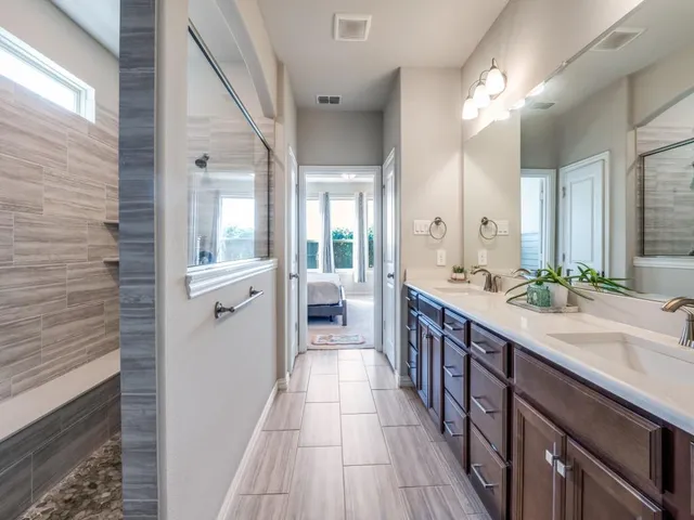 a spacious bathroom with a double vanity sink and a mirror