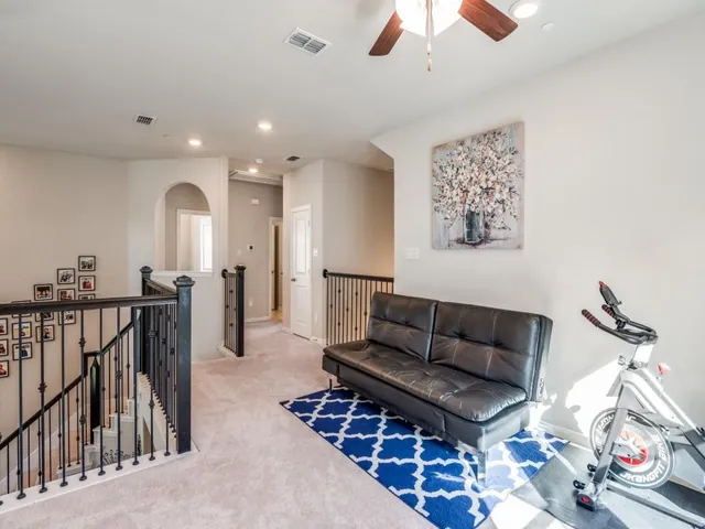 a living room with furniture ceiling fan and a rug